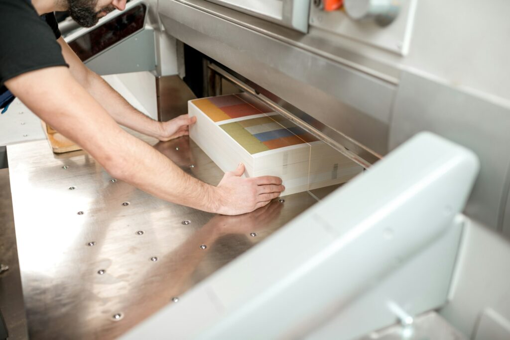 Cutting a stack of paper for printing at the factory